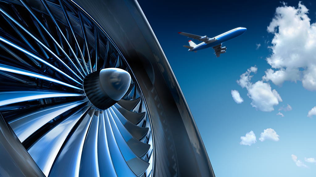 Bild mit Turbine links im Vordergrund und einem Verkehrsflugzeug darüber vor blauem Himmel mit weißen Wolken