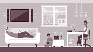 Family in living room with various digital devices and mobile phone-based smart home devices