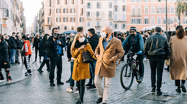 People in face masks strolling in Piazza di Spagna, Rome, Italy during the Covid pandemic