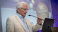 Portrait of Herbert Paschen while giving a speech 